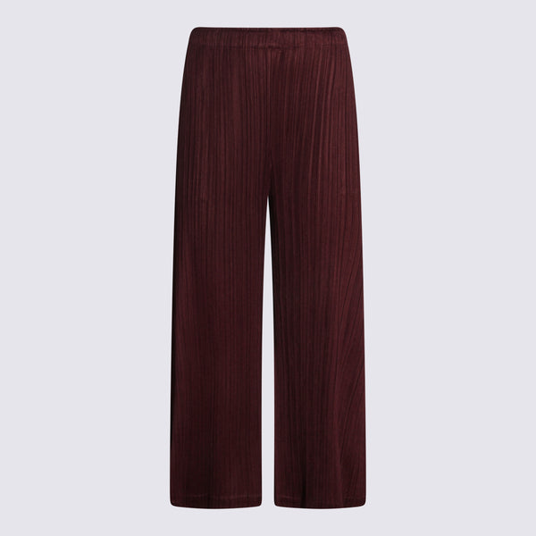 Pleats Please Issey Miyake 100% Polyester trousers in burgundy