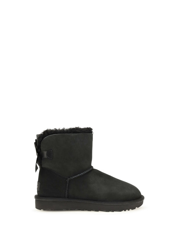 UGG Upper: sheepskin and suede; Sole: rubber boot in black