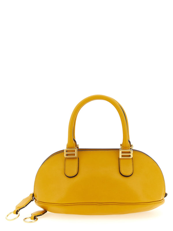 توب بوليرو من Balenciaga وحقيبة مقبض — أصفر