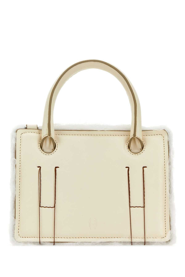 Dentro Tracolla Exterior: 100% Calf Leather; Lining: 100% Leather; Finishing: Silver metal top handle bag in cream