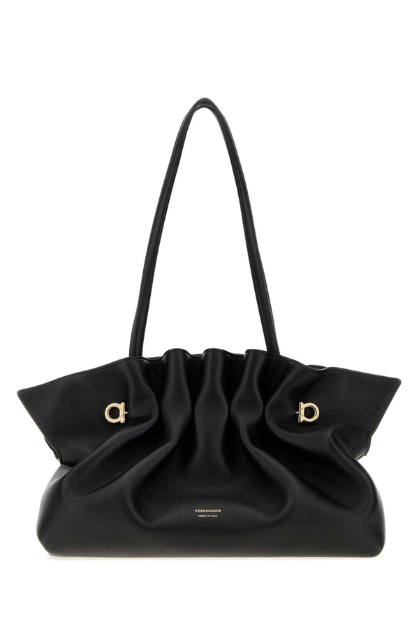 Ferragamo Neronero Exterior: 100% Lamb; Lining: 100% Fabric; Finishing: Golden metal shoulder bag in black