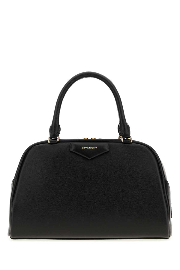 Givenchy East Exterior: 100% Calf; Lining: 100% Fabric; Finishing: Golden metal top handle bag in black
