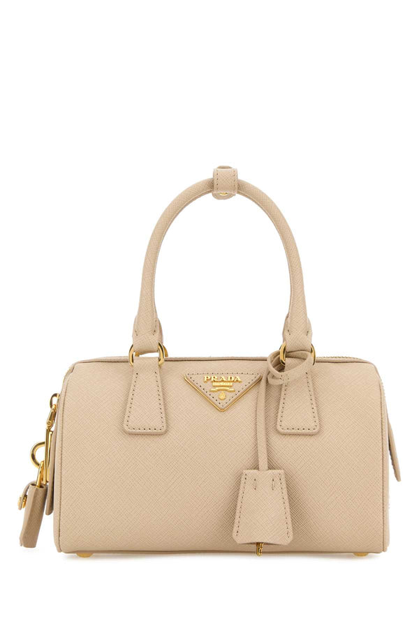 Prada Exterior: 100% Leather; Lining: 100% Fabric; Finishing: Golden metal top handle bag in beige