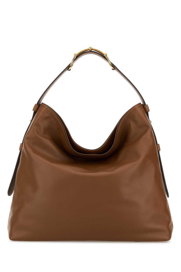 Gucci Exterior: 100% Leather; Lining: 100% Fabric; Finishing: Golden metal shoulder bag in brown
