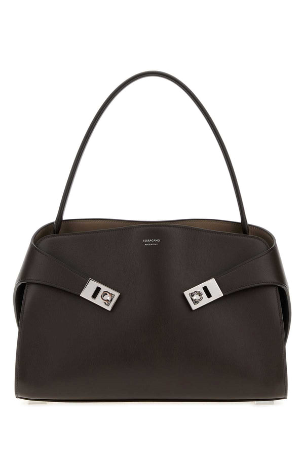 Ferragamo Exterior: 100% Calf Lining: 100% Leather Finishing: Silver metal shoulder bag in brown