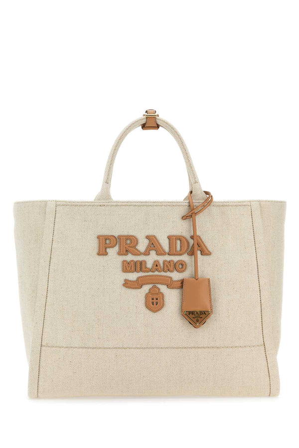 Prada Exterior: 100% Fabric; Lining: 100% Fabric; Finishing: Golden metal tote bag in beige