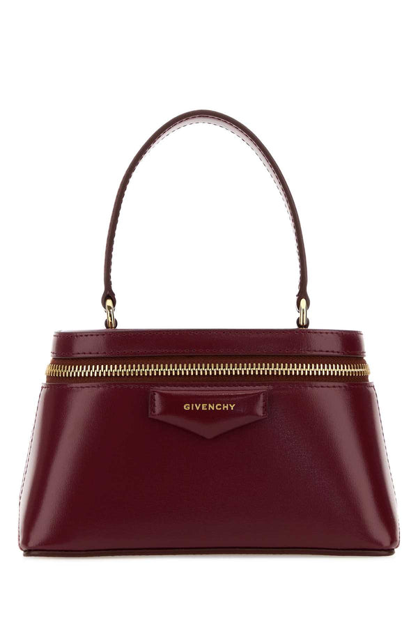 Givenchy Exterior: 100% Calf. Lining: 100% Nappa leather. Finishing: Golden metal top handle bag in burgundy