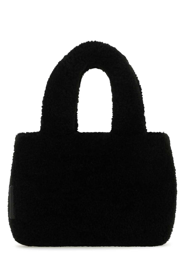 Amina Muaddi Mano Exterior: 100% Shearling top handle bag in black