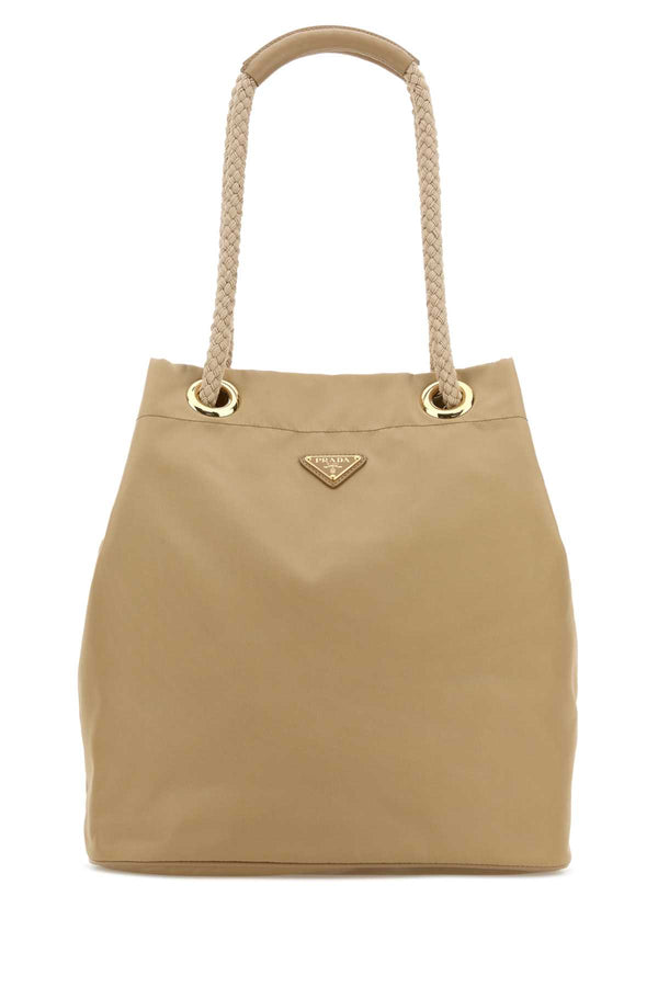 Prada Exterior: 100% Fabric (Re-Nylon); Lining: 100% Fabric; Finishing: Golden metal bucket bag in beige