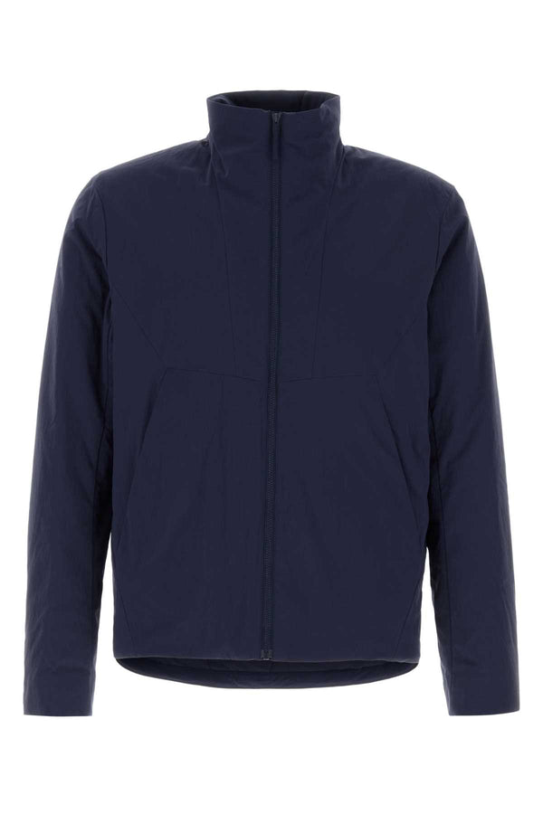 Veilance Insulated Exterior: 95% Nylon 5% Elastane; Lining: 88% Nylon 12% Elastane jacket in navy
