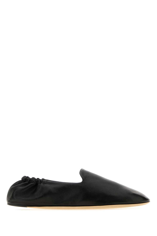 The Row Slipper Exterior: 100% Lamb Interior: 100% Leather Sole: Leather flat in black