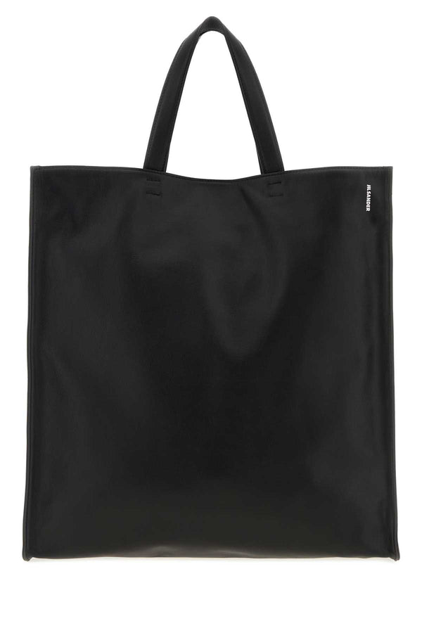 Jil Sander Tote Exterior: 100% Calf Lining: 100% Fabric Finishing: Silver metal tote bag in black