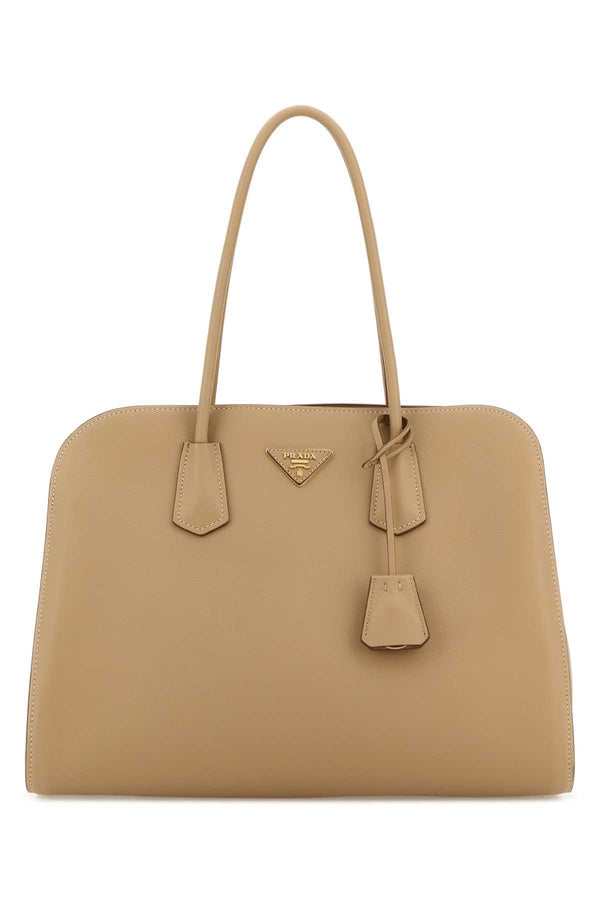 Prada Exterior: 100% Leather; Lining: 100% Fabric; Finishing: Golden metal shoulder bag in beige