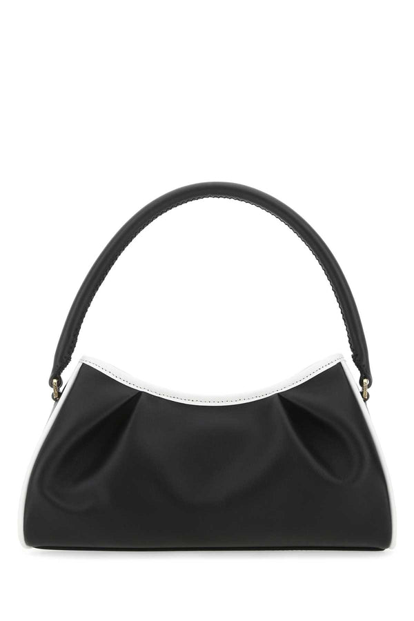 Elleme Exterior: 100% Bovine leather; Lining: 100% Suede; Finishing: Golden metal shoulder bag in black