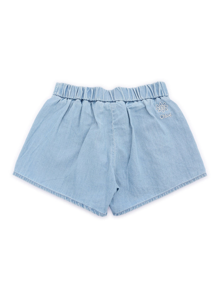 Shorts 100% organic cotton light denim. Fancy scallop pattern finish at leg bottoms. Elasticated waist back. Gold color Chlo� branded buttons. Tone on Chloe embroidery Blue