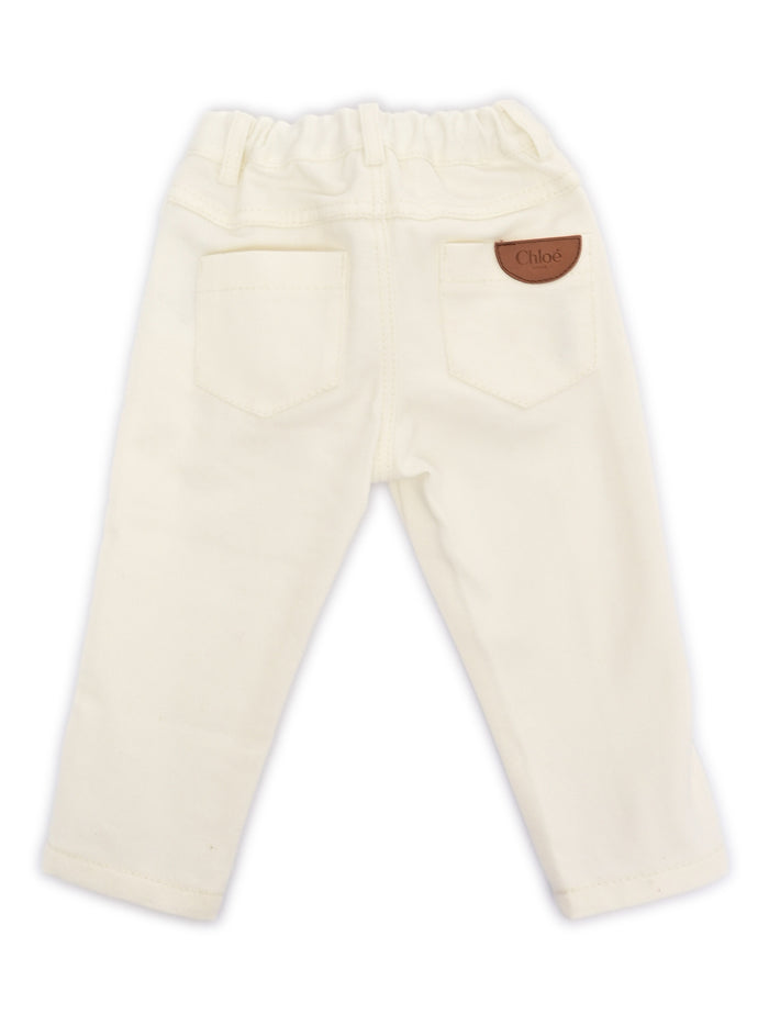 Five-pocket organic drill pants with scallops on front. Waist and zipper fly closure, Chlo� branded button. Paris cow leather label at back (leather source : Italy). Model inspired by the adult collections. White Cotton Lining Jean