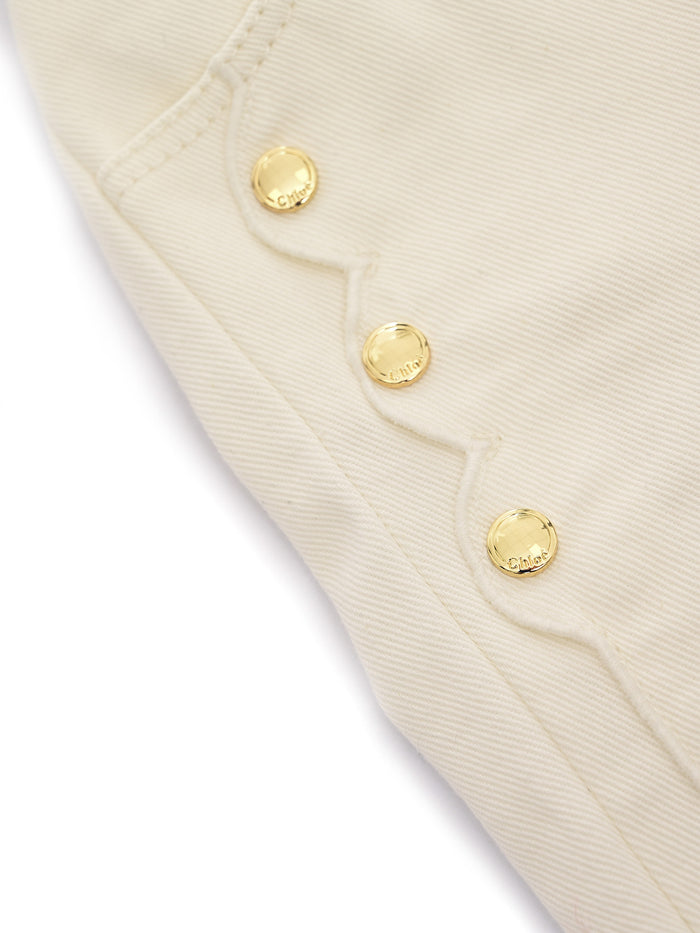 Five-pocket organic drill pants with scallops on front. Waist and zipper fly closure, Chlo� branded button. Paris cow leather label at back (leather source : Italy). Model inspired by the adult collections. White Cotton Lining Jean