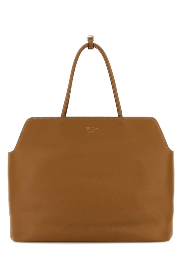 Prada Exterior: 100% Leather; Lining: 100% Fabric; Finishing: Golden metal shoulder bag in brown