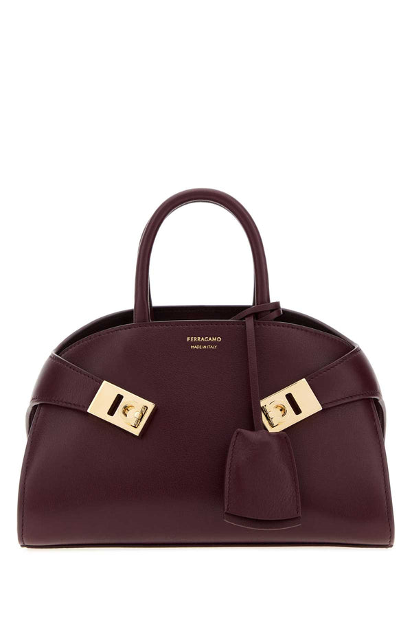 Ferragamo Exterior: 100% calf leather; Lining: 100% leather; Hardware: gold-tone metal handbag in purple