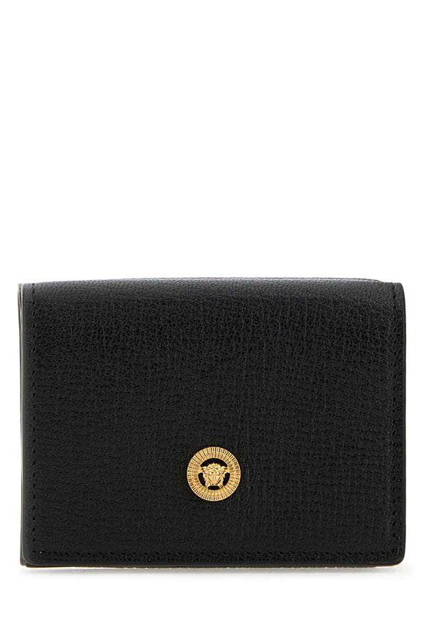 Versace Wallet Exterior: 100% Ovine leather; Finishing: Golden metal wallet in black
