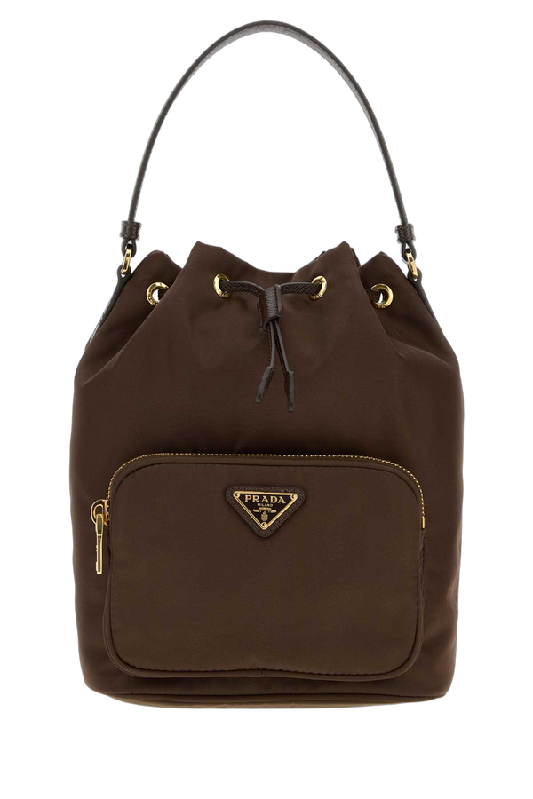 Prada Exterior: 100% Re-Nylon. Lining: 100% Fabric. Finishing: Golden metal. bucket bag in brown