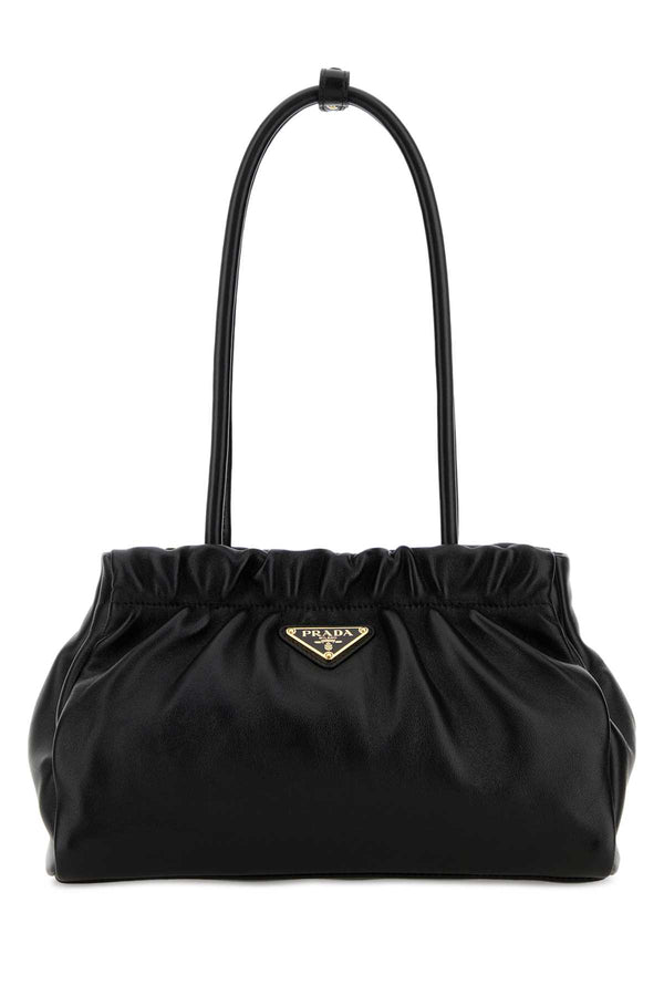 Prada Mano Exterior: 100% Nappa leather; Lining: 100% Fabric; Finishing: Golden metal shoulder bag in black