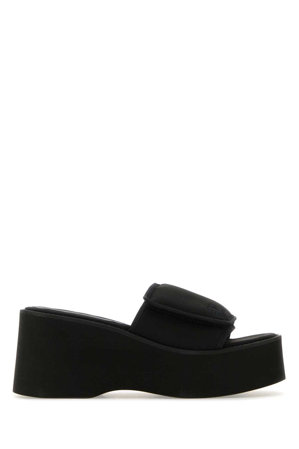 Courreges Exterior: 54% Polyester 38% Nylon 8% Elastane; Interior: 100% Leather 100% Fabric; Sole: Rubber slipper in black