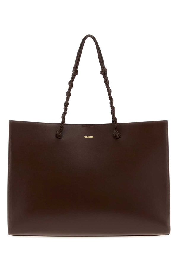 Jil Sander Exterior: 100% Calf Lining: 100% Nappa leather Finishing: Golden metal tote bag in brown