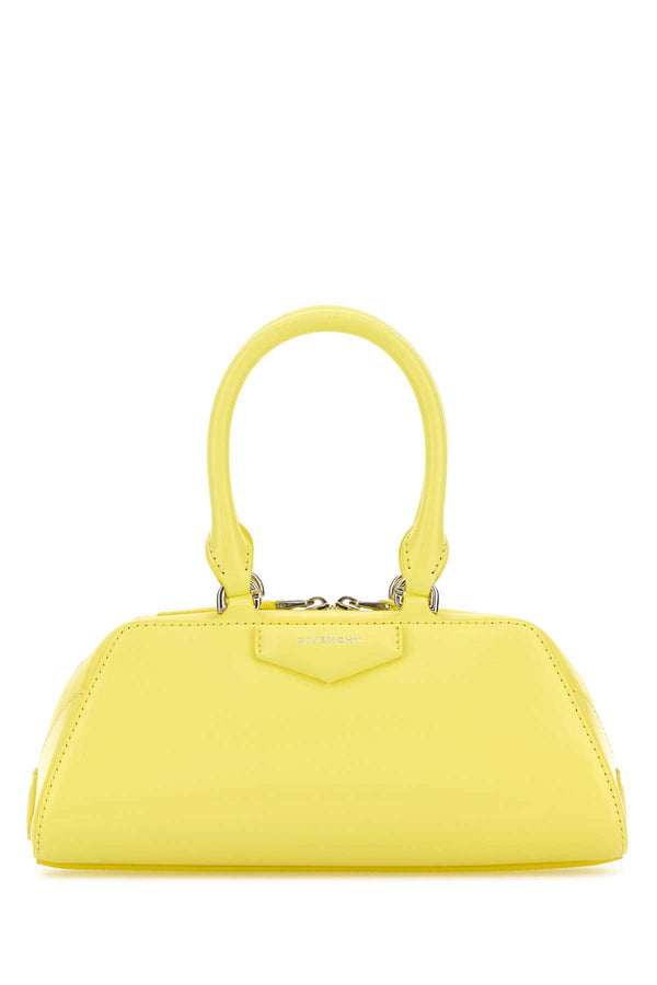 Givenchy East Exterior: 100% Calf Lining: 90% Cotton 10% Polyester Finishing: Silver metal top handle bag in yellow