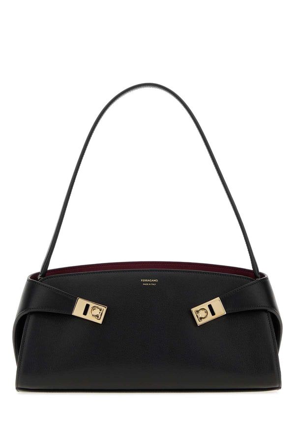 Ferragamo Exterior: 100% Calf Lining: 100% Calf Finishing: Golden metal shoulder bag in black