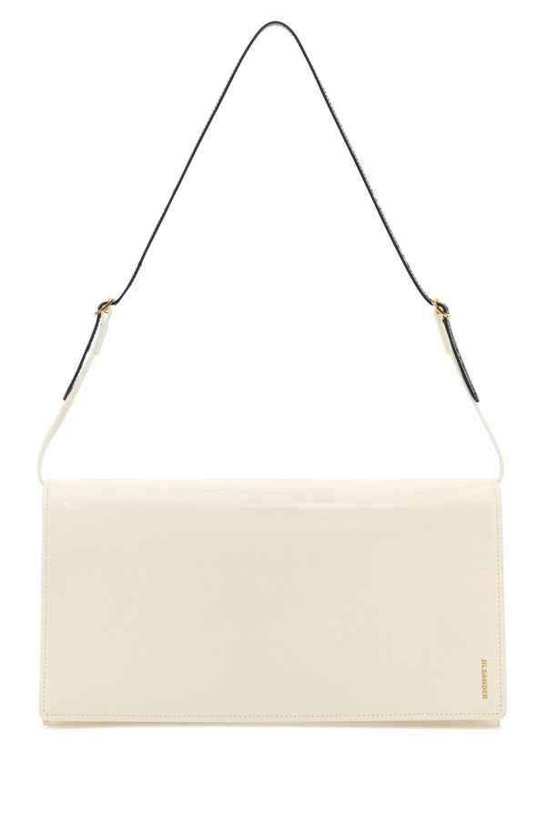 Jil Sander Exterior: 100% Calf Lining: 100% Nappa leather Finishing: Golden metal shoulder bag in white