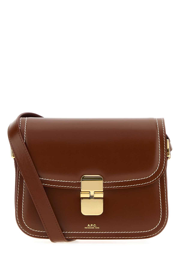 A.P.C. Exterior: 100% Bovine leather; Lining: 100% Fabric; Finishing: Golden metal shoulder bag in brown