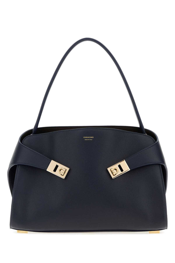 Ferragamo Exterior: 100% Calf; Lining: 100% Leather; Finishing: Golden metal shoulder bag in navy