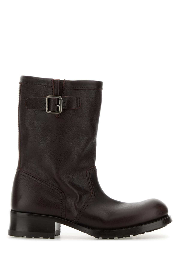 Prada Exterior: 100% Calf Leather; Interior: 100% Leather; Sole: Rubber ankle boot in brown