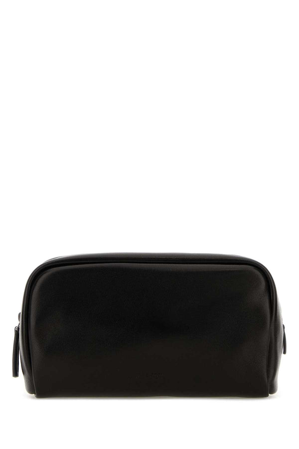 The Row Pouch Exterior: 100% Lamb. Lining: 100% Leather. Finishing: Silver metal travel wallet in black