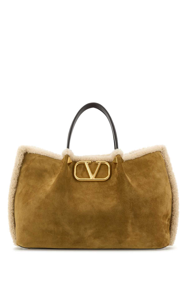 Valentino Garavani Tote Exterior: 100% Suede; Lining: 100% Shearling; Finishing: Antiqued golden metal tote bag in brown