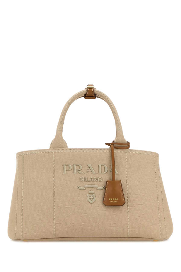 Prada Exterior: 100% Fabric; Lining: 100% Fabric; Finishing: Golden metal top handle bag in beige
