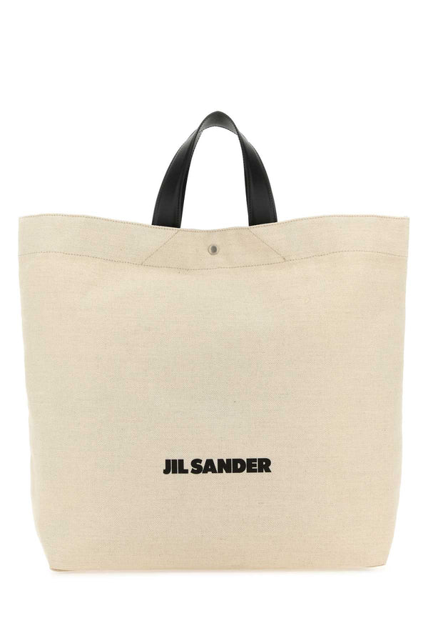 Jil Sander Exterior: 70% Cotton 30% Linen; Handles: 100% Leather; Finishing: Silver Metal tote bag in beige