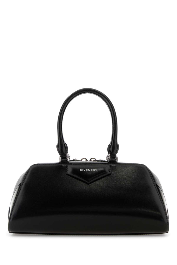 Givenchy East Exterior: 100% Calf Lining: 90% Cotton 10% Polyester Finishing: Silver metal top handle bag in black